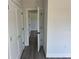 Hallway with neutral walls, white trim, and doorways leading to multiple rooms at 202 Bromwich Dr, Kissimmee, FL 34758
