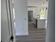 Modern kitchen featuring white cabinetry, stainless steel appliances, marble countertops, and island sink at 202 Bromwich Dr, Kissimmee, FL 34758