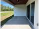 Back patio of the home, featuring a stained wood ceiling, fan, and large open backyard area at 202 Bromwich Dr, Kissimmee, FL 34758