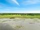 Expansive view of homes on a scenic lot with a dock, lake frontage, and lush green surroundings at 2525 Ridgeway Dr, Kissimmee, FL 34746