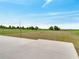 Manicured lawn and expansive concrete patio ideal for outdoor activities and relaxation with string lights at 2525 Ridgeway Dr, Kissimmee, FL 34746