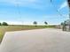 Expansive concrete backyard featuring string lights and serene views of the surrounding landscape at 2525 Ridgeway Dr, Kissimmee, FL 34746