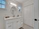 Bright bathroom featuring white cabinetry, a modern vanity, sleek hardware, and a large mirror at 2525 Ridgeway Dr, Kissimmee, FL 34746