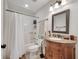 Bathroom with a vanity, decorative framed mirror, and a shower and tub combination at 2525 Ridgeway Dr, Kissimmee, FL 34746