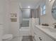 Well-lit bathroom featuring a shower-tub combo, sleek fixtures, and a tiled shower with a built-in niche at 2525 Ridgeway Dr, Kissimmee, FL 34746
