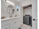 Bathroom with modern vanity and closet with washer-dryer hookups, offering convenience and style at 2525 Ridgeway Dr, Kissimmee, FL 34746