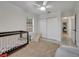 Bright bedroom featuring a crib, white trim, closet, and plush rug at 2525 Ridgeway Dr, Kissimmee, FL 34746