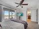 Bright bedroom with light carpet, a ceiling fan and sliding glass doors leading to the patio at 2525 Ridgeway Dr, Kissimmee, FL 34746