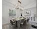 A dining room with a modern chandelier and marble table at 2525 Ridgeway Dr, Kissimmee, FL 34746