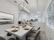 A dining room with a modern chandelier and marble table open to kitchen at 2525 Ridgeway Dr, Kissimmee, FL 34746