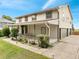 Side view of the two-story home, showcasing the covered porch and attached garage at 2525 Ridgeway Dr, Kissimmee, FL 34746
