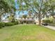 Charming two-story home features a large, well-maintained lawn and mature trees at 2525 Ridgeway Dr, Kissimmee, FL 34746