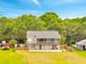 Two-story house with large yard, screened porch, and ground level patio surrounded by lush trees at 2525 Ridgeway Dr, Kissimmee, FL 34746