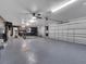 Spacious garage with epoxy flooring and ample storage space is ready for vehicle storage and DIY projects at 2525 Ridgeway Dr, Kissimmee, FL 34746