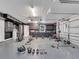 Garage gym boasts lots of storage, natural light, and a variety of workout equipment for a great fitness space at 2525 Ridgeway Dr, Kissimmee, FL 34746