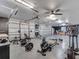 Well-equipped garage gym area with exercise machines and weights, and ample storage at 2525 Ridgeway Dr, Kissimmee, FL 34746
