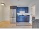 Kitchenette area featuring navy blue cabinets and stainless steel refrigerator at 2525 Ridgeway Dr, Kissimmee, FL 34746
