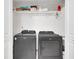 Laundry room features modern, side-by-side washer and dryer for convenient laundry access at 2525 Ridgeway Dr, Kissimmee, FL 34746