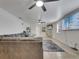 Living room featuring plush sofa, tile floors, and multiple televisions at 2525 Ridgeway Dr, Kissimmee, FL 34746