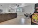 Living room features gaming arcade machines, tile floors, plush sofa, and multiple televisions at 2525 Ridgeway Dr, Kissimmee, FL 34746