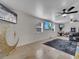 Spacious living room featuring multiple televisions, tile flooring, and a decorative crescent moon at 2525 Ridgeway Dr, Kissimmee, FL 34746