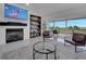 Cozy living room with a fireplace, TV, and sliding glass doors opening to a screened-in lanai with a view at 2525 Ridgeway Dr, Kissimmee, FL 34746
