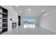 Bright living room showcasing fireplace, built-in shelving, and sliding glass doors to a deck at 2525 Ridgeway Dr, Kissimmee, FL 34746