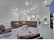 Bright living room with a brown sectional, fireplace, and open access to the kitchen area at 2525 Ridgeway Dr, Kissimmee, FL 34746