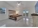 Bright main bedroom featuring a decorative ceiling fan, ensuite bathroom, and outdoor access at 2525 Ridgeway Dr, Kissimmee, FL 34746