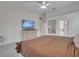 The main bedroom features a TV and a ensuite bathroom with a large mirror and plenty of counter space at 2525 Ridgeway Dr, Kissimmee, FL 34746
