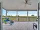 A covered outdoor patio provides seamless indoor-outdoor living and lush views of the surrounding landscape at 2525 Ridgeway Dr, Kissimmee, FL 34746