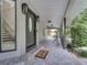 Covered front porch with welcome mat and outdoor seating at 2525 Ridgeway Dr, Kissimmee, FL 34746