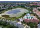 Aerial view of neighborhood with community pool, waterpark, pond and lush landscaping around the community at 2585 Maneshaw Ln, Kissimmee, FL 34747