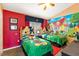 Colorful ' bedroom featuring two beds with cartoon-themed bedding and playful decor at 2585 Maneshaw Ln, Kissimmee, FL 34747