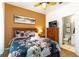 Cozy bedroom featuring a queen bed, floral bedding, and ensuite bathroom at 2585 Maneshaw Ln, Kissimmee, FL 34747