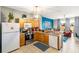 Kitchen complete with wooden cabinets, breakfast bar, and modern appliances including dishwasher and stove at 2585 Maneshaw Ln, Kissimmee, FL 34747