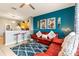 Open-concept living room featuring stylish furniture, colorful decor, and seamless flow to the kitchen area at 2585 Maneshaw Ln, Kissimmee, FL 34747