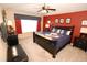 Spacious main bedroom with a comfortable bed, cozy bedding, and a peaceful ambiance at 2585 Maneshaw Ln, Kissimmee, FL 34747