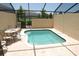 Private screened-in pool with brick paver decking, surrounded by comfortable seating at 2585 Maneshaw Ln, Kissimmee, FL 34747