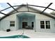 Backyard showcasing the covered patio, sliding glass doors, and an inviting outdoor space at 2591 Oneida Loop, Kissimmee, FL 34747