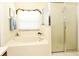 Bathroom featuring a garden tub, a window with decorative trim, and a glass-enclosed shower at 2591 Oneida Loop, Kissimmee, FL 34747