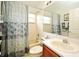 The bathroom showcases a vanity sink, a toilet, and a shower tub with a curtain at 2591 Oneida Loop, Kissimmee, FL 34747