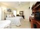 A peaceful bedroom with a metal bed, a wooden desk, and plenty of sunlight at 2591 Oneida Loop, Kissimmee, FL 34747
