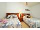 A cozy bedroom with two beds, each adorned with unique floral bedspreads and colorful pillows at 2591 Oneida Loop, Kissimmee, FL 34747