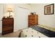 Simple bedroom featuring wooden dressers, a closet, and a comfortable bed setup at 2591 Oneida Loop, Kissimmee, FL 34747