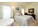 Cozy bedroom with natural light, a decorative bed frame, and a serene, inviting atmosphere at 2591 Oneida Loop, Kissimmee, FL 34747