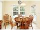 Bright dining area featuring a round table, four chairs, and a view of the pool outside at 2591 Oneida Loop, Kissimmee, FL 34747