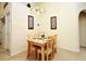 Cozy dining room with chandelier, carpeted floors and a simple wooden table with 4 chairs at 2591 Oneida Loop, Kissimmee, FL 34747