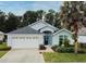 Charming single-Gathering home with a well-manicured lawn, two car garage and a side palm tree at 2591 Oneida Loop, Kissimmee, FL 34747