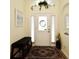 Welcoming foyer featuring a bench seat and neutral decor with a decorative wreath on the front door at 2591 Oneida Loop, Kissimmee, FL 34747